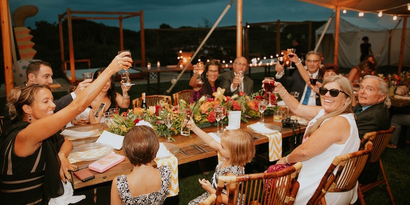 family-enjoying-meal-outside-table