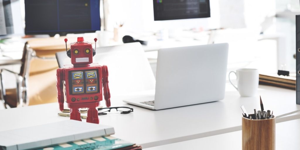 toy-robot-stood-on-empty-desk